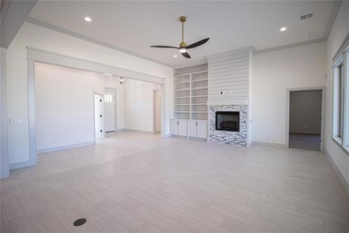 Unfurnished living room with ceiling fan, a stone 