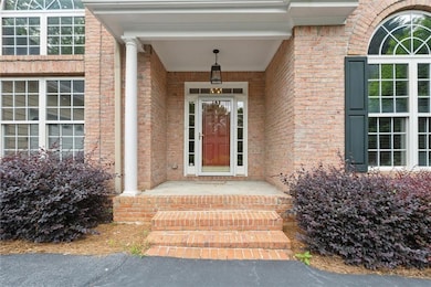 Property entrance featuring brick siding