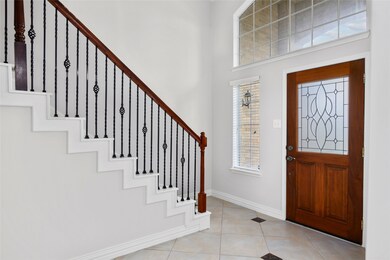 Natural light shines through the front entry of this home! Tiled throughout the main living areas on the first floor.