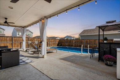 Fenced backyard featuring a ceiling fan and a patio area