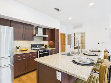 Kitchen featuring freestanding refrigerator, rang