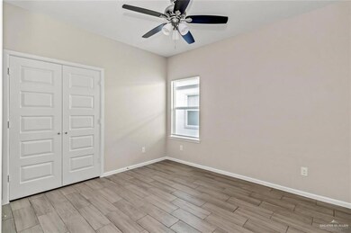 Unfurnished bedroom with wood tiled floors, a closet, and a ceiling fan