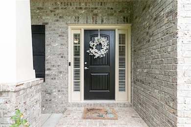 View of exterior entry featuring brick siding