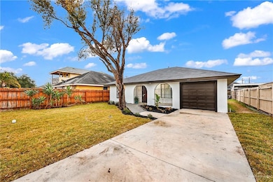 View of front of house with driveway, a garage, and stucco siding