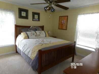Bedroom with carpet floors, baseboards, crown mold