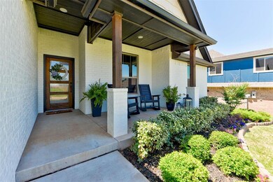 Doorway to property featuring a porch and brick siding