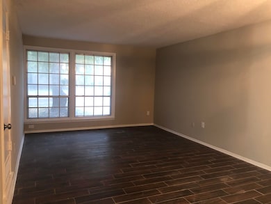 Spare room featuring dark wood finished floors and