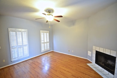 Fireplace, pretty plantation shutters, ceiling fan