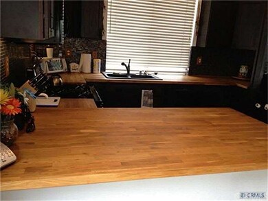 Butcherblock countertop, mosaic wall.