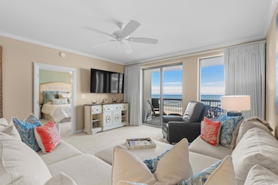 Living room with light colored carpet, ornamental molding, and a ceiling fan