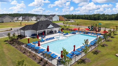 View of swimming pool with a lawn and a patio area