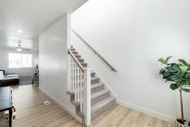 Staircase with wood finished floors, recessed lighting, and a ceiling fan