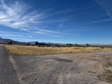 View of asphalt street featuring a mountain view and a view of countryside