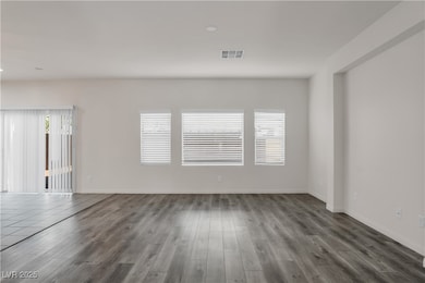 Spare room featuring wood finished floors and baseboards
