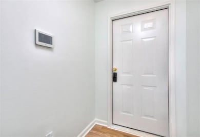 Entryway with baseboards and light wood-style floors