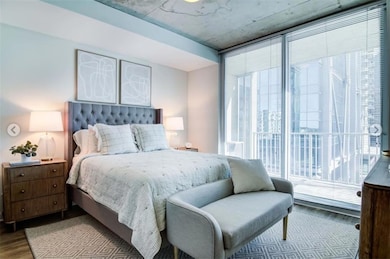 Bedroom with light hardwood / wood-style flooring