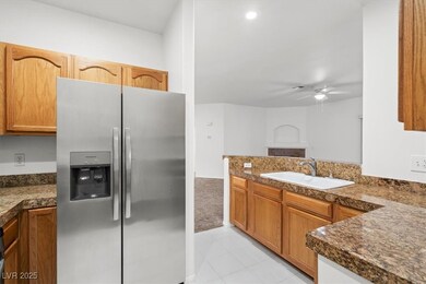 Kitchen with a ceiling fan, a peninsula, a sink, d