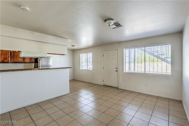Kitchen featuring freestanding refrigerator, light