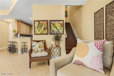 Living area with stairway, baseboards, light tile patterned floors, and recessed lighting