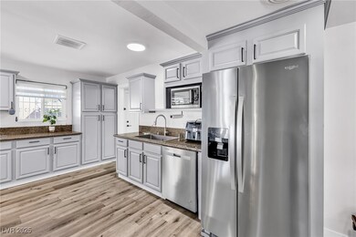 Kitchen featuring visible vents, stainless steel a