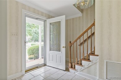 Entrance foyer featuring an inviting chandelier, c