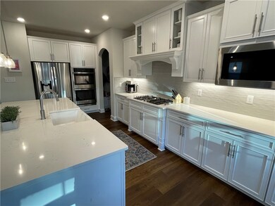 Gourmet kitchen with stainless appliances, under c