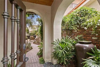 Inviting, private brick-path entry with lush lands