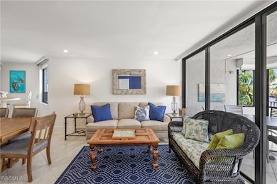 Living room with light tile patterned floors and recessed lighting