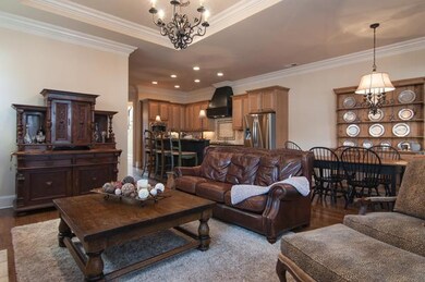 Open concept living area with beautiful wood floors and fireplace