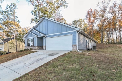 View of front of property featuring a garage, cool