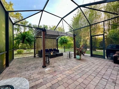 View of patio featuring outdoor lounge area, a lanai, a grill, and a pergola