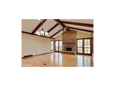 Stacked stone floor to ceiling fireplace * Hardwoo