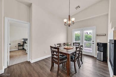 Formal dining area with vaulted ceilings and French doors to the balcony.