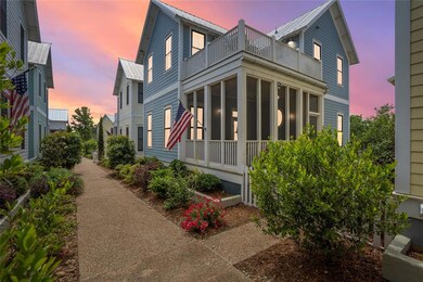 View of front of house featuring a balcony and a s