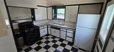 Kitchen featuring freestanding refrigerator, blac