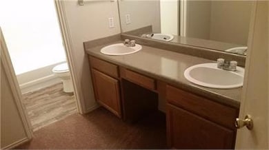Bathroom with toilet and double vanity
