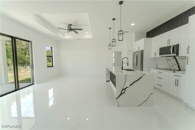 Kitchen with stainless steel appliances, a sink, m