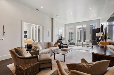 Living area featuring wood finished floors and recessed lighting