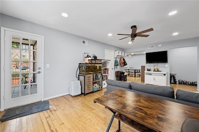 Living area with ceiling fan, light wood-type flooring, recessed lighting, and baseboards