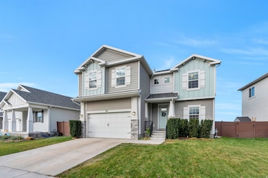 Craftsman inspired home with board and batten siding, stone siding, a garage, and driveway