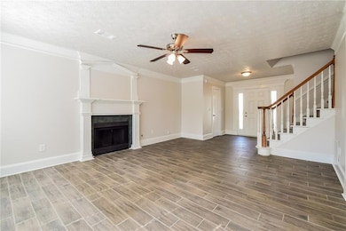Unfurnished living room with stairway, a ceiling f