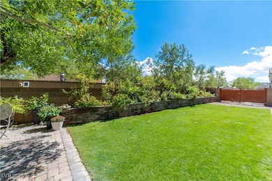 Fenced backyard with a patio, REAL grass, flower garden, gated for possible boat/toy space or just an extra space for play.