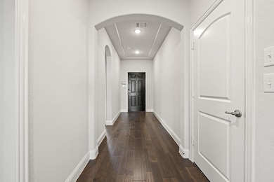 Hallway with dark hardwood / wood-style floors