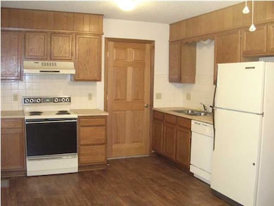 Kitchen w/ Appliances + Dining Area