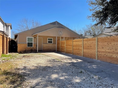 Rear view of property with brick siding, driveway