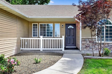 Entrance to property with roof with shingles, a porch, and stone siding