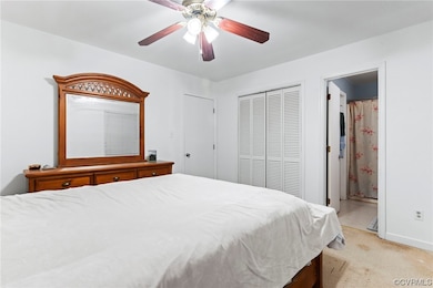 Carpeted bedroom featuring ensuite bathroom, ceili