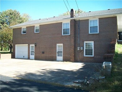back view showing basement and car garage