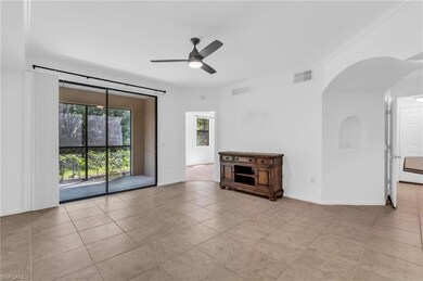 Tiled empty room featuring ceiling fan and crown m