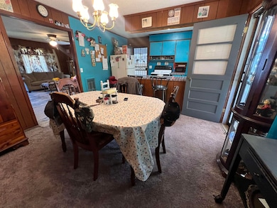 Dining space with carpet flooring and ceiling fan 
